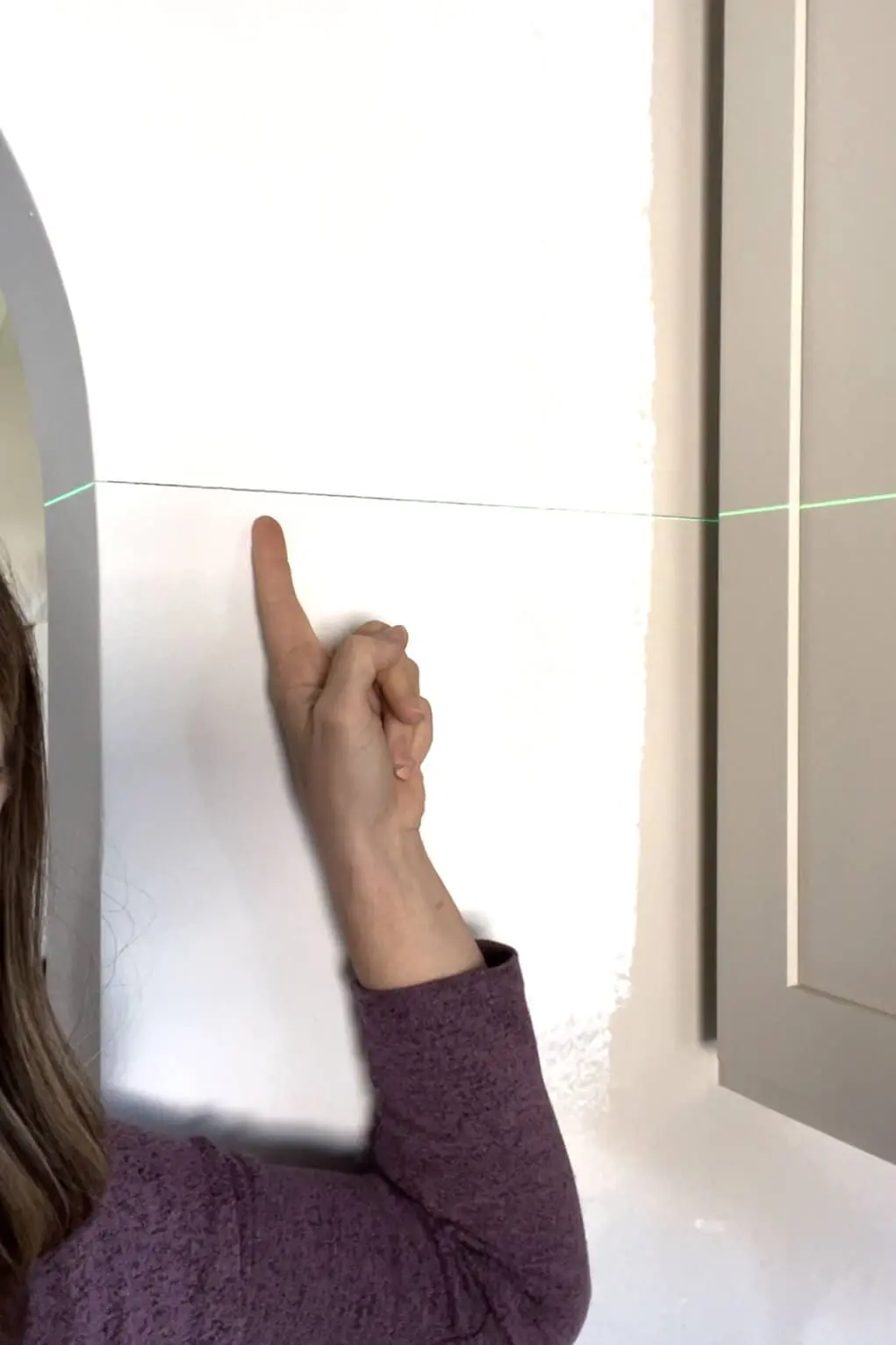 Installing a DIY shiplap backsplash.